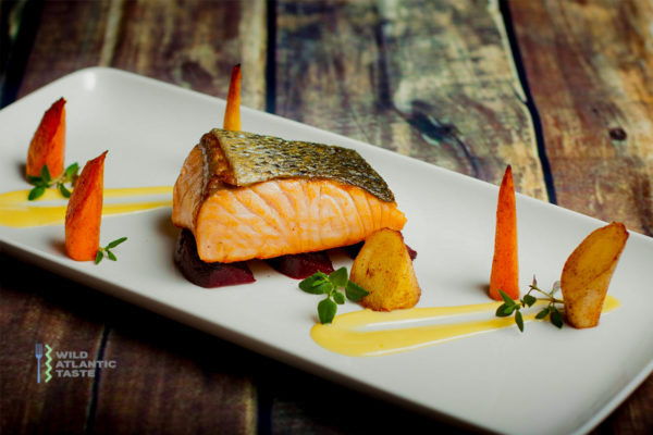 Roast Atlantic salmon with root vegetables and beurre blanc sauce